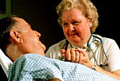 Geriatric care: elderly man reassured by nurse