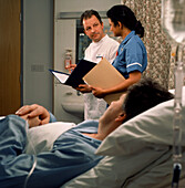 Patient watching nurses discuss his case