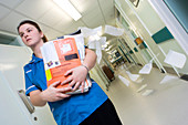 Nurse carrying patient records