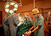 Surgeon & assistants at work during operation