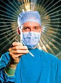 Surgeon in surgical dress holds a scalpel