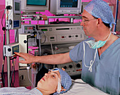 Anaesthetist & patient with consciousness monitor