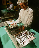 Medical technician preparing surgical instruments