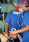 Surgeons checking a male patient prior to surgery