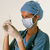 Female anaesthetist checking a syringe
