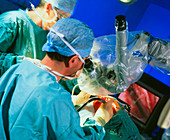 Surgeon conducting cochlear implant ear surgery