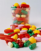 Assortment of antibiotic drugs,some in a cup
