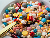 Spoonful of assorted pills,tablets and capsules