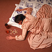 Woman lying on the floor following a drug overdose