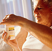Elderly woman taking calcium pills