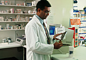 Pharmacist counting out tablets for a prescription