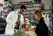 Pharmacist showing a volumatic adaptor to a woman