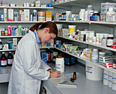 A pharmacist filling in a prescription