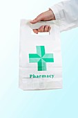Pharmacist carrying a pharmacy bag