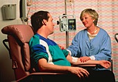 Chemotherapy: seated man with IV drip in arm