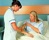 Nurse injecting female patient in upper arm