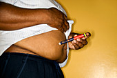 Diabetic man self-injecting insulin