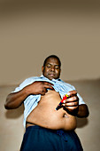 Diabetic man self-injecting insulin