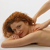 Woman receives a neck and shoulder massage