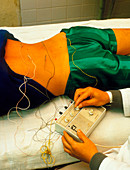 Electro-acupuncture therapy on a patient's back