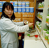 Pharmacist dispensing herbal medicine