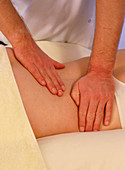 Osteopath treating the back of a patient