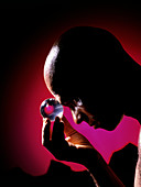 Abstract image of man gazing into a crystal ball
