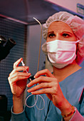 IVF: technician holding embryo transfer catheter