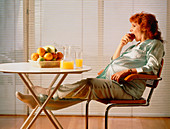 Pregnant woman eating apple & drinking fruit juice