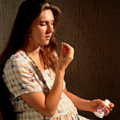 Pregnant woman taking folic acid enriched vitamins