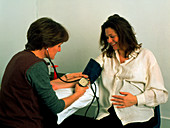 Pregnant woman's blood pressure taken