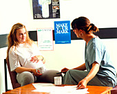 Midwife with pregnant woman in an antenatal clinic