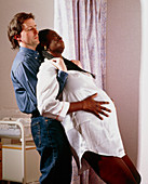 Pregnant woman being supported during early labour