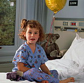 Young girl on a bed in a paediatric ward