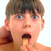 Teenage boy having a throat examination