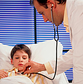 Doctor examines a boy's chest with a stethoscope