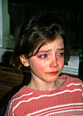 An eight year old girl crying