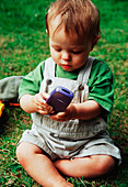 Baby playing with mobile phone