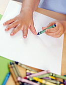 Girl drawing around her hand