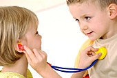 Children playing with a toy stethoscope