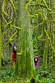 Mother and daughter playing in a forest