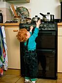 Child safety; child reaching for pan on cooker