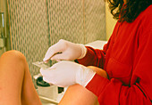 Nurse performing a cervical smear test