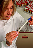 Female medical technician holding a vaginal swab