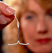 Woman holds intrauterine contraceptive device