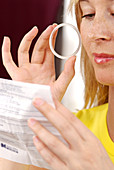 Woman reading female condom information