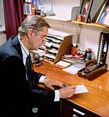 General practitioner writing out a prescription
