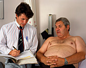 GP doctor in consultation with an obese man