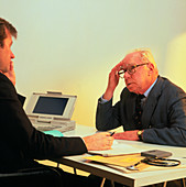 Elderly man in consultation with his GP doctor
