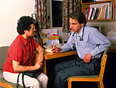 Male GP doctor in consultation with a patient